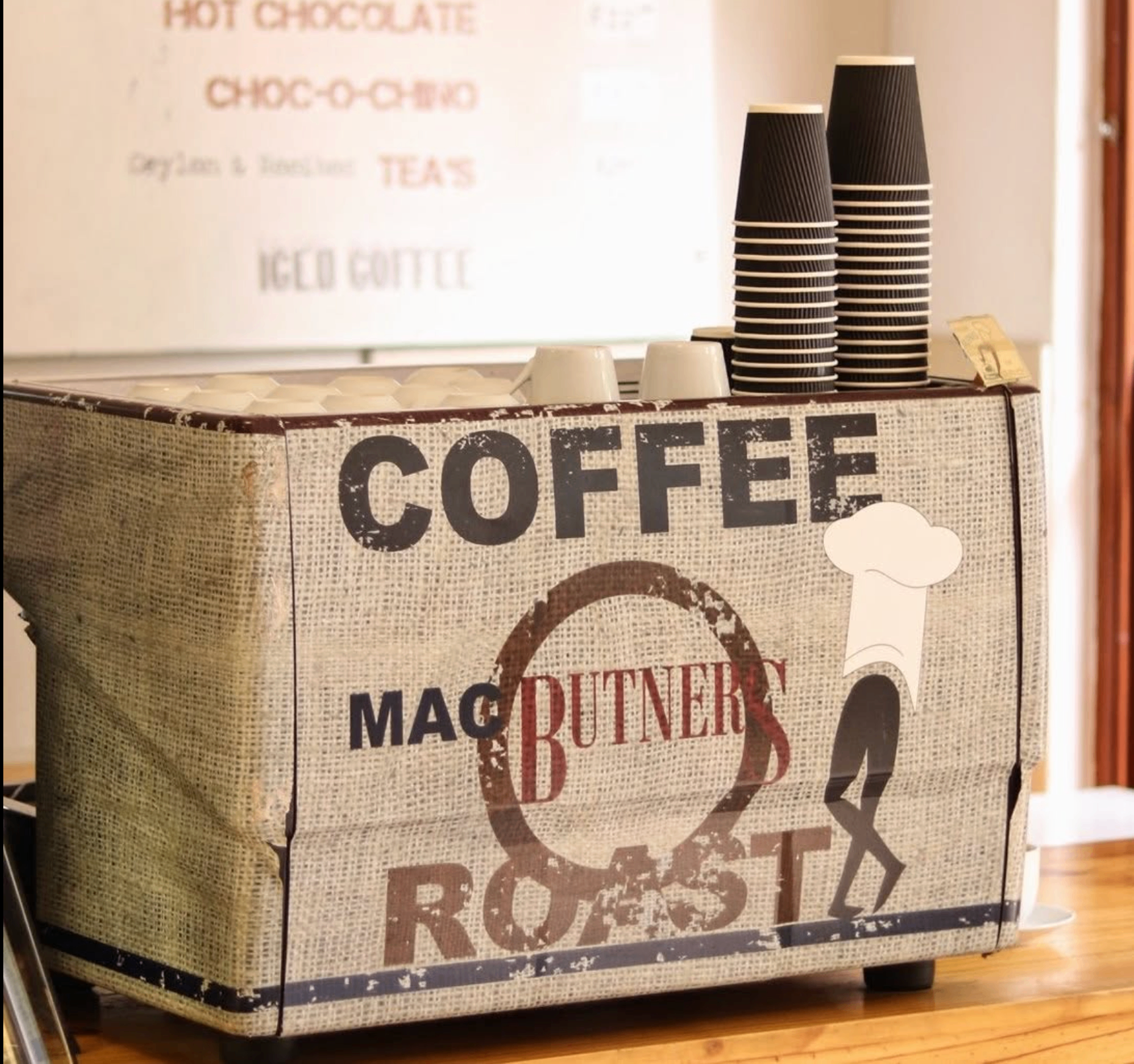 Mac Butners coffee machine wrapped in hessian with takeaway cups